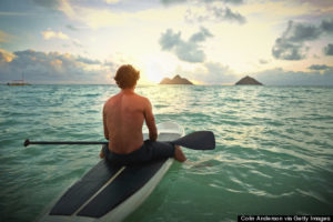 Caucasian man on paddle board in ocean